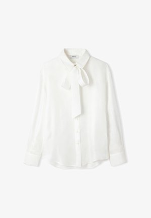 Witte blouse van textuur stof, met een kraag en een gestrikte strik rond de hals, lange mouwen en een knoopsluiting aan de voorkant.