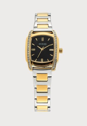 Златен и сребърен метален часовник Guess с черен циферблат, златни часови индекси и кристали по златния безел.