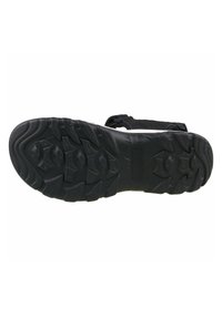 Black sports sandal sole with textured rubber tread, featuring a grip pattern and curved edges for improved traction. Adjustable straps attached.