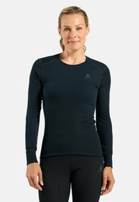 Long-sleeve thermal top in dark navy, made of soft, ribbed fabric with a fitted design. Features flatlock seams and a logo on the chest.