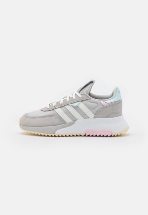 Szary sneaker Adidas z białymi paskami, beżową podeszwą, pastelowoniebieskimi i różowymi akcentami, widok z profilu na białym tle.