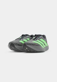 Gray athletic shoes with a textured pattern and neon green stripes, featuring a cushioned sole and rounded toe design.