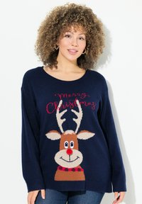 Marinblå stickad tröja med en ren grafik med röd näsa, horn och blommig krage. Texten säger "God Jul" i röd.