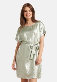 Shiny green metallic dress with a relaxed fit, short sleeves, and a belt tie at the waist. Smooth texture with a subtle sheen.