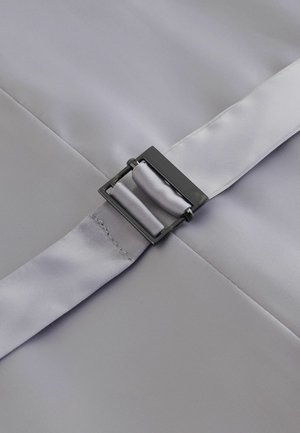 Sidabrinio pilko atspalvio diržas su blizgiu paviršiumi, turintis stačiakampį juodą metalinį užsegimą ir lygią audinio tekstūrą, matomi siūlų kraštai.