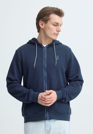 Felpa con cappuccio blu navy con zip, cappuccio, coulisse grigie, tessuto strutturato e logo sul lato sinistro del petto. Vestibilità comoda, maniche lunghe.