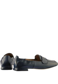 Navy leather loafers featuring a textured finish, flat heel, and a rounded toe with a stitched accent across the vamp.