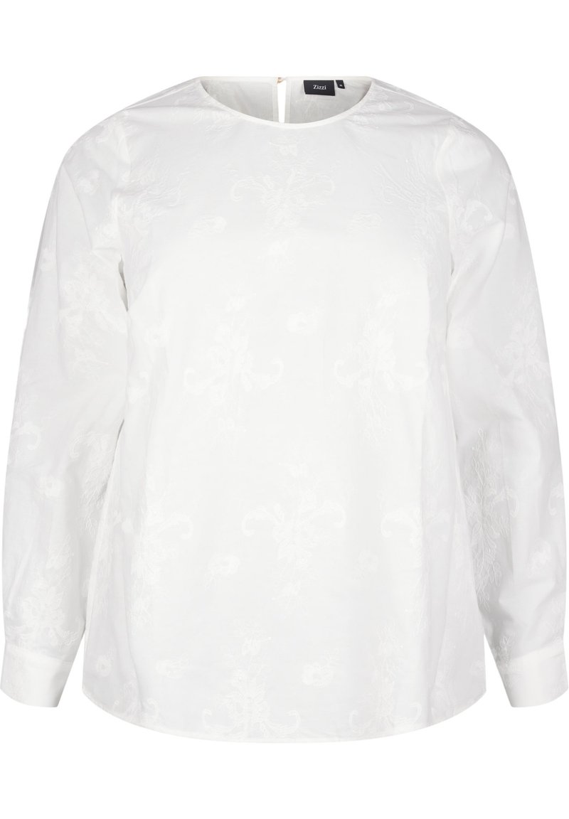 Blusa bianca con maniche lunghe, scollo rotondo e una sottile texture floreale. Presenta un'apertura a forma di chiave sul retro con una cerniera. Materiale in cotone morbido.