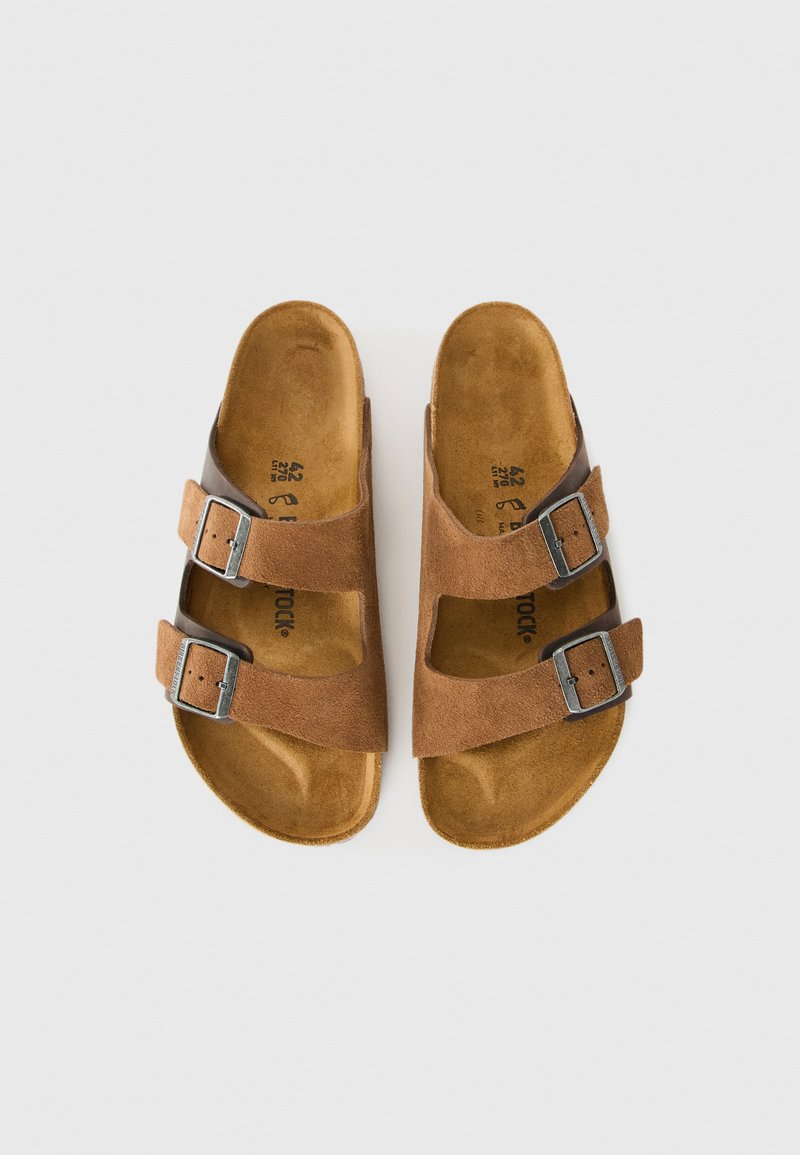 Un paio di sandali in suede marrone con due cinturini regolabili con fibbie, plantari sagomati color tan e indicazioni delle taglie all'interno.