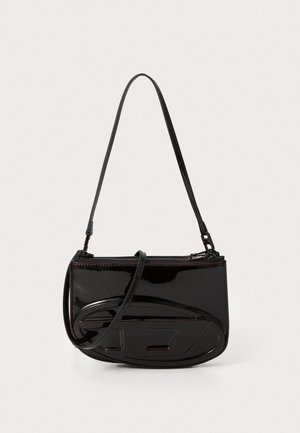 Black patent leather crossbody bag with a sleek, rectangular shape, featuring a zip closure and embossed design on the front.