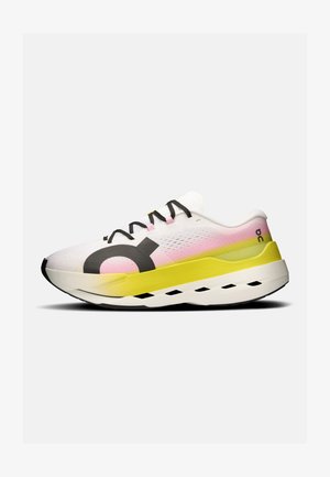 Sport shoes with a white upper featuring pink and yellow accents, a large black logo, and a thick white sole with black pattern detailing.