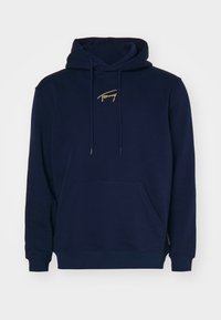 Granatowa bluza z kapturem wykonana z mieszanki bawełny, z kieszenią z przodu, sznurkami do regulacji oraz haftowanym złotym logo na klatce piersiowej. Tkanina wstępnie skurczona.