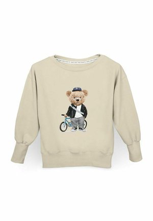 Beżowy sweter z grafiką niedźwiedzia w okularach, kurtce i czapce, stojącego obok niebieskiego roweru. Prążkowane mankiety i dół.
