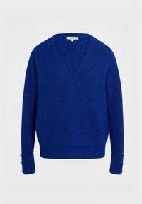 Maglione blu lavorato a maglia con scollatura a V, texture a coste e dettagli di bottoni argentati sulle maniche. Materiale morbido e vestibilità rilassata.