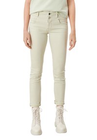 Beżowe, obcisłe dżinsy z mieszanki bawełny o gładkiej fakturze. Posiadają zapięcie na dwa guziki, pięć kieszeni oraz podwinięte mankiety.