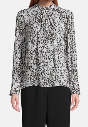 Blusa a maniche lunghe in grigio chiaro con un motivo astratto nero, dotata di un colletto e polsini arricciati. Tessuto morbido con una vestibilità rilassata.