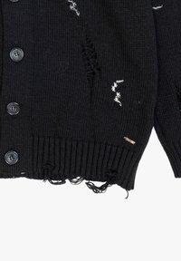 Zwarte gebreide cardigan met een ribbelzoom, zes knoopsluitingen en versleten details met witte draadaccenten. Afgebroken randen aan de onderkant.