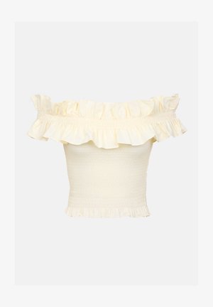 Haut décolleté en jaune clair, avec un col à volants et un corps froncé. Texture douce avec des accents de volants au bas.