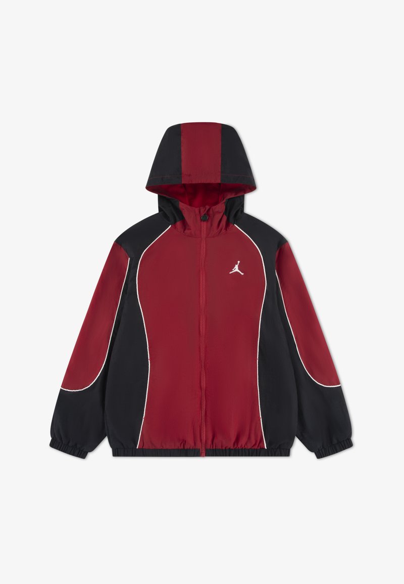 Κόκκινο και μαύρο αντιανεμικό τζάκετ με κουκούλα, φερμουάρ μπροστά και λευκές ραφές. Διαθέτει λογότυπο στο στήθος και ελαστικές μανσέτες. Ελαφρύ ύφασμα.