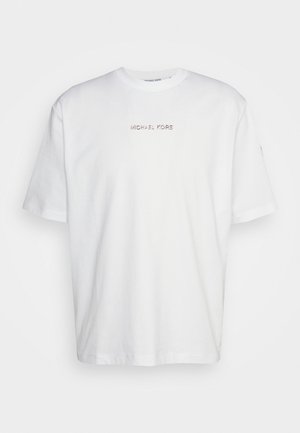 Hvid bomulds T-shirt med rund hals, korte ærmer og et metallisk "MICHAEL KORS" logo centreret på brystet. Glat tekstur.