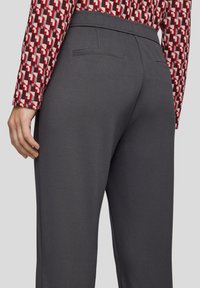 Grau Bedruckte mit einer strukturierten Oberfläche, ausgestattet mit einem glatten Bund und Gesäßtaschen, kombiniert mit einem gemusterten Langarmoberteil.