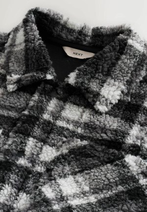 Texturierte schwarz-graue kariert Jacke aus weichem, flauschigem Material mit scharfem Kragen und sichtbaren Nähdetails. Markenetikett ist enthalten.