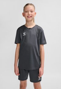 Graues Sportoutfit mit einem kurzärmeligen T-Shirt mit V-Ausschnitt und passenden Shorts, aus glattem, leichtem Material gefertigt.