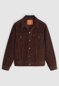 Bruine corduroy jas met een puntige kraag, twee borstzakken, zijzakken en drukknopen aan de voorkant. Textiel met een geribbelde structuur.
