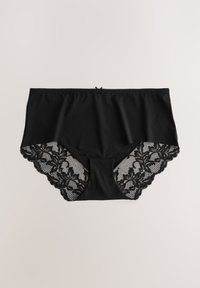 Schwarze Unterwäsche mit einer glatten Stoffvorderseite und einem kunstvoll gestalteten schwarzen Spitzenrücken mit floralen Mustern und gewellten Kanten. Kleine Schleife am Bund als Akzent.