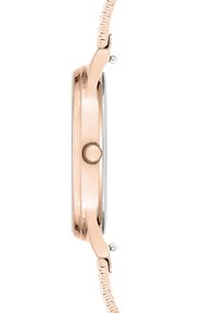 Roségoldene Metalluhr mit schlankem Profil, geprägt von sanften Kurven, einer auffälligen Krone und einem gemusterten Armband.