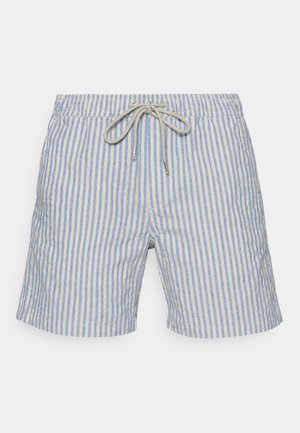 Raikkaat uimarannat vaaleansinisessä ja beigen raidallisessa kuosissa, joissa on nauhakuja metallipäillä ja tekstuuroituneen kankaan viimeistely.