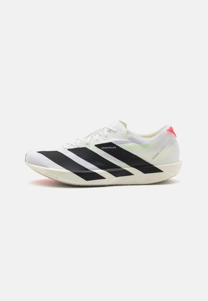 White athletic shoe with black diagonal stripes, lightweight mesh material, green accents, and red heel tab; features a sleek, elongated design.