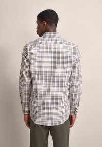 Karierte Langarmbluse in Weiß-, Grün- und lila Tönen. Sie verfügt über einen klassischen Kragen, Knopfmanschetten und einen abgerundeten Saum.