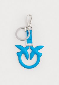 Chaveiro azul em couro com duas silhuetas de pássaros, preso a um clipe e anel de metal prateado para a fixação de chaves. Textura suave e cor vibrante.