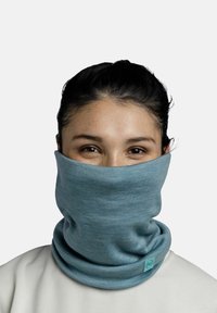 Blue knitted neck gaiter made of soft fabric, featuring a smooth texture and a small label detail at the front. Visible folds in the material.