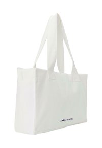 Baltos drobės maišelis su pailgomis rankenomis, turintis stačiakampio formą ir išsiuvinėtą tamsiai mėlynos spalvos tekstą apačioje.