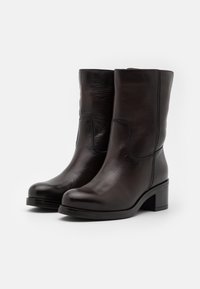 Stivaletti neri in pelle con punta rotonda, design semplice e tacco a blocco. Presentano una texture liscia e un delicato dettaglio di cucitura.