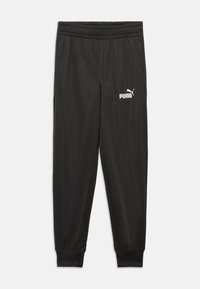 Pantalons de sport noirs avec une taille élastique, des poignets de jambes fuselés et un logo Puma imprimé en blanc sur la cuisse gauche. Texture de tissu lisse.