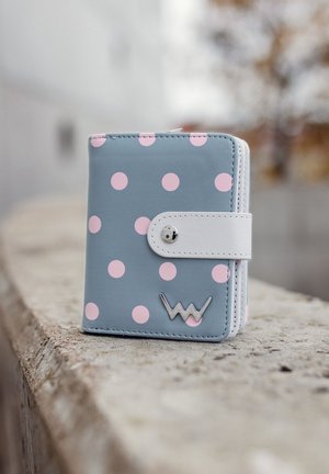 Gray wallet with pink polka dots, white snap closure, and silver logo. Smooth leather texture with folded edges and compact design.