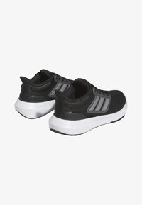 Scarpe da ginnastica nere con una tomaia in mesh testurizzato, accenti grigi e marchio a tre strisce. Presentano un'intersuola bianca e una suola in gomma curva.