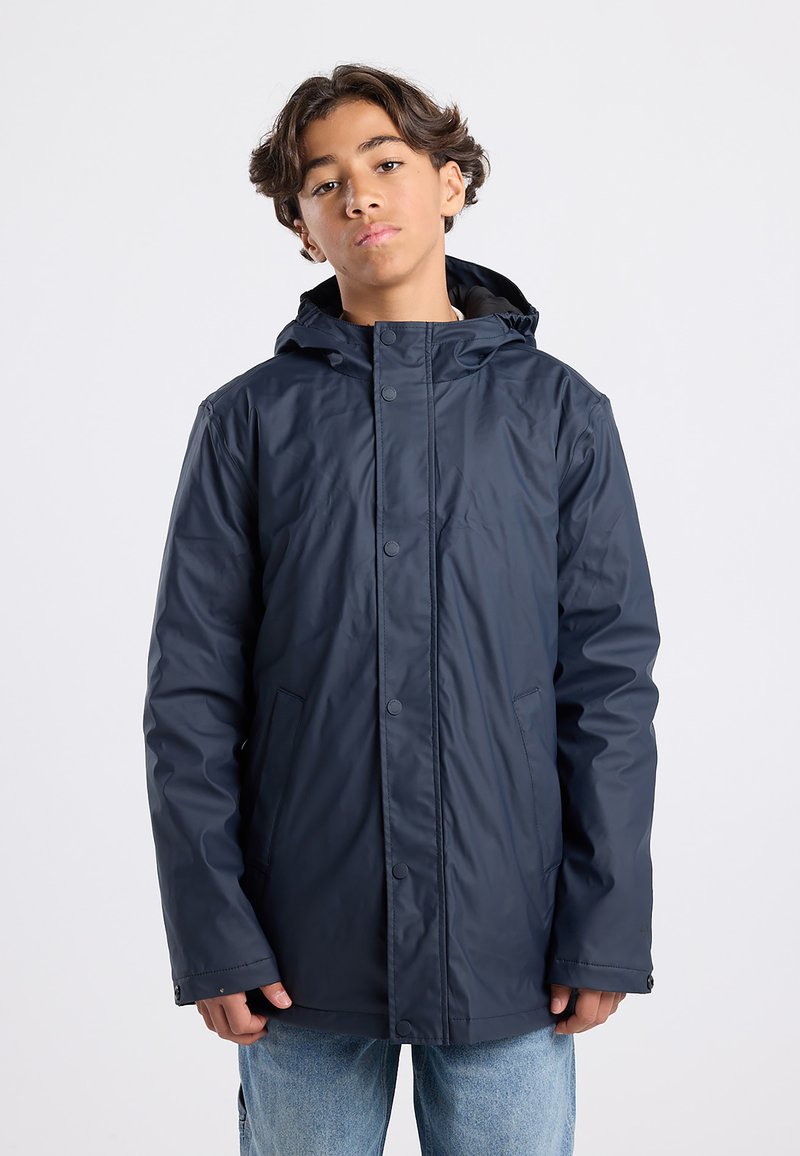 Navy waterproof jacket featuring a hood, snap buttons, and side pockets. Lightweight material with smooth texture, designed for warmth and comfort.