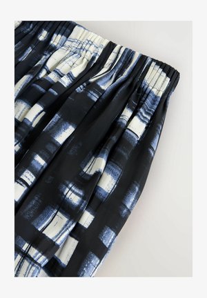 Black fabric skirt with pleats, featuring a blue and white geometric pattern. Elastic waist and smooth texture.