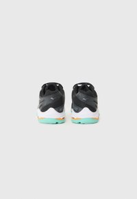 Black athletic shoes with gray and white accents. Features a textured upper, lightweight sole, and a mint green outsole with orange details.