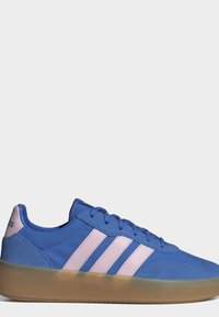 Blue sneaker with pink stripes, lace-up design, and translucent gum sole, showing Adidas branding on heel tab.