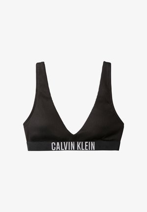 Zwart geribbeld bralette van zachte stof met diepe V-halslijn en brede band met het "CALVIN KLEIN" logo in witte letters.