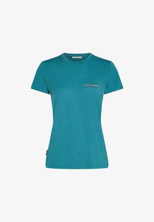 T-shirt a maniche corte color teal con collo a giro e logo "icebreaker" in rosa sul lato sinistro del petto, e una piccola etichetta nera sul fianco.