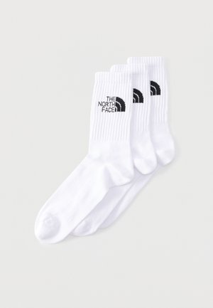 Trei perechi de șosete albe până la gambă cu manșete rebele, fiecare având un logo negru „The North Face” pe lateral.