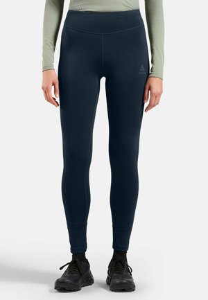 Marineblaue Leggings aus dehnbarem Stoff, mit hohem Taillenbündchen und dezentem Logodetail am Oberschenkel. Glattes, körpernahes Design.