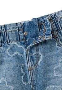 Bermudas de mezclilla en un color azul claro, con cintura elástica, textura desvaída y patrones en forma de nubes con detalles de costura en contraste.