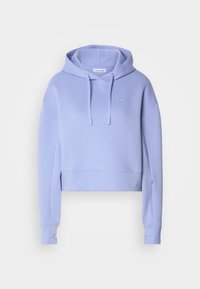 Haut cropped en lavande avec capuche à cordon, manches longues, poignets côtelés et un petit logo sur la poitrine. Fabriqué en matière douce de sweat-shirt.